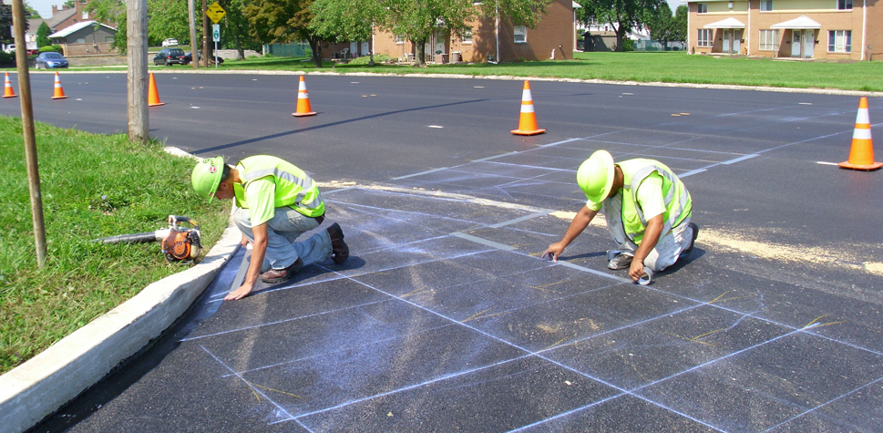 Two construction workers performing job in safety and hi vis clothing