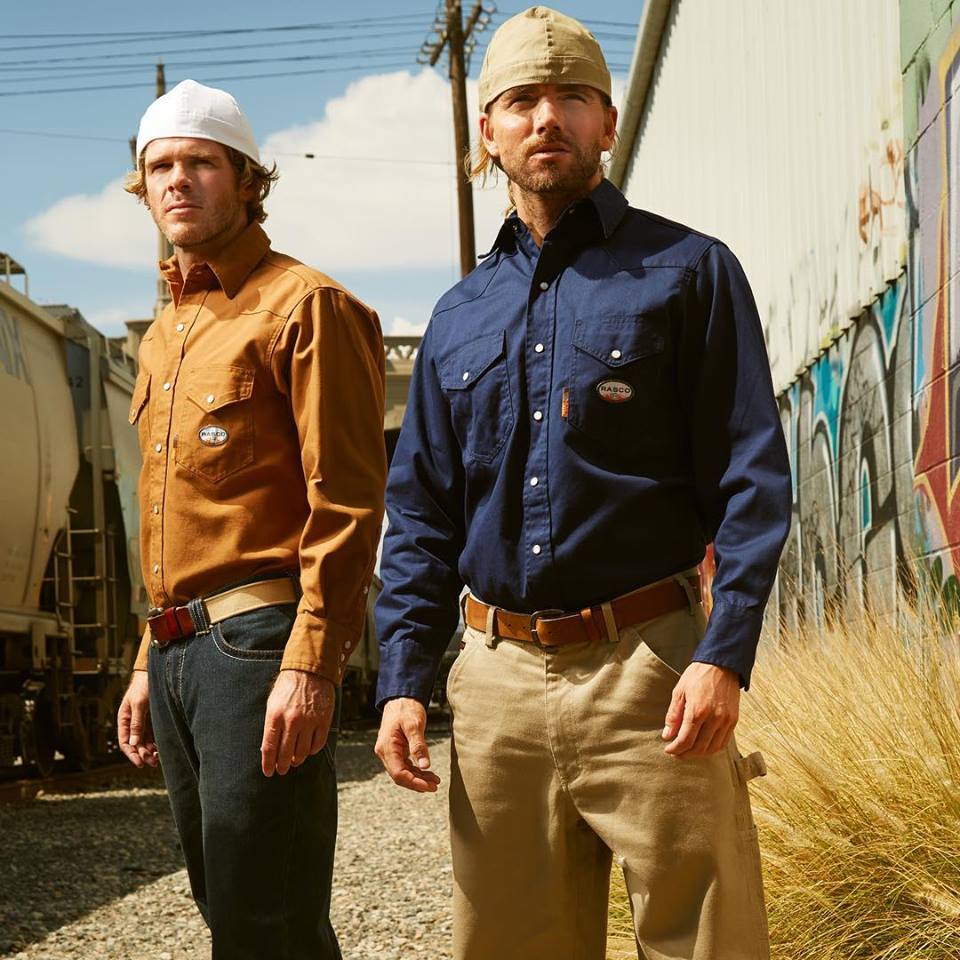 Two men wearing flame resistant shirts outside