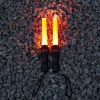 traffic control flashlights two foxfire baton flashlights on and lying on a bay of rocks