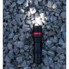 single traffic control flashlight foxfire baton flashlight lying on a bay of rocks